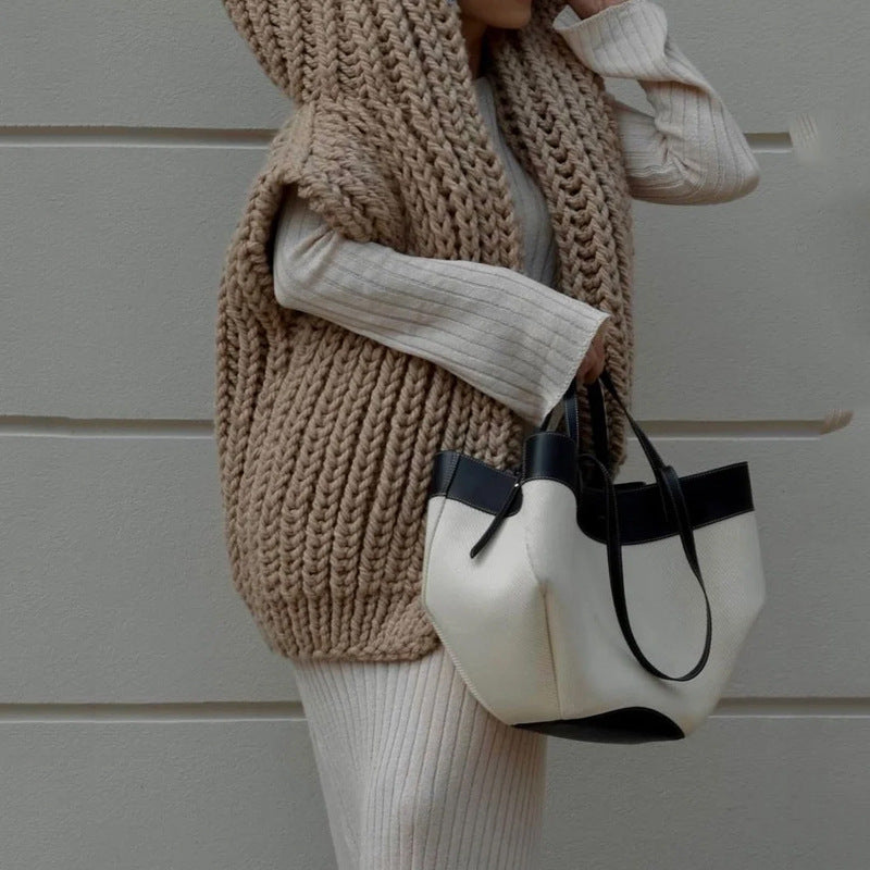 Woman wearing beige CozyNest sleeveless knit vest for women with handbag